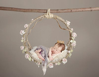 artistic-newborn-photograph-of-baby-in-floral-circle-swing